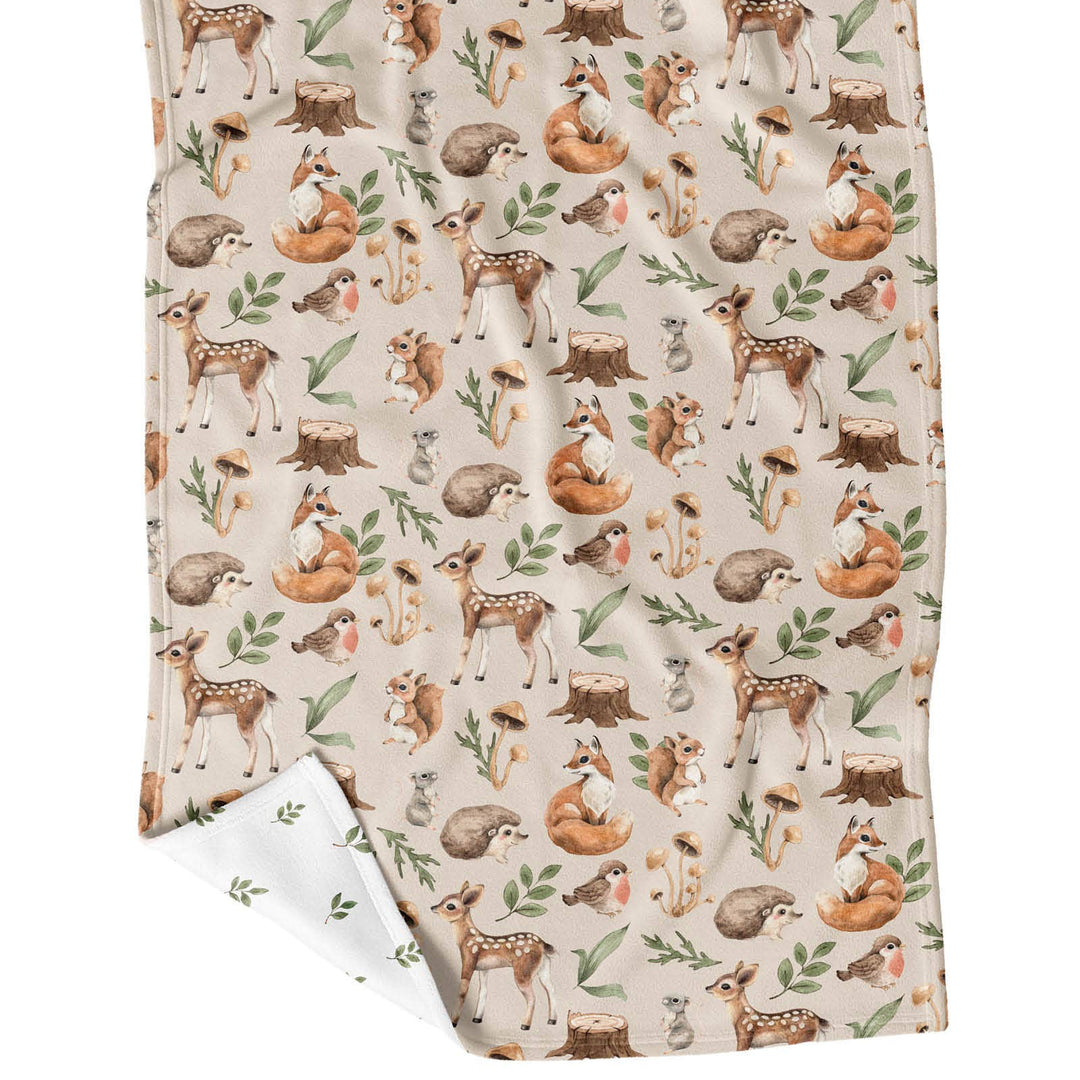 Flannel fabric with woodland animal pattern on a white background