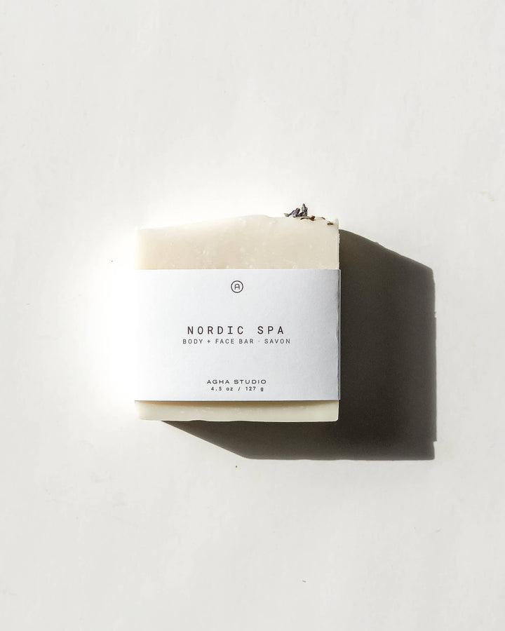 Bar of soap with a white label on a light gray background