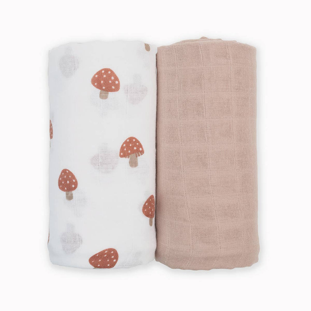 Two swaddle blankets, one with mushroom pattern and one solid color, on a white background.