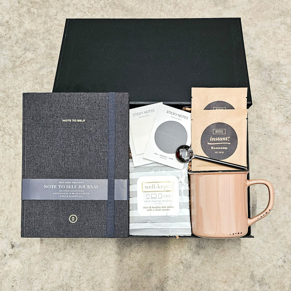 Curated for the discerning individual, this gift box combines elegance and functionality with items including a black linen journal from Wit & Delight, stylish sticky notes/page markers from Rosie Papeterie, a chic beige enamel look mug, Rosso Coffee's exquisite instant coffee packages, practical screen wipes from Well-Kept, a sleek black coffee spoon, all beautifully packaged in a Lux Box with hand-packing and a personalized handwritten note card.
