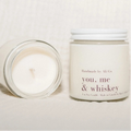 Candle and jar labeled 'You, Me & Whiskey' on a light background