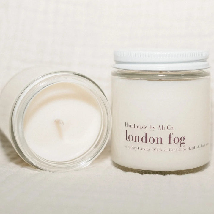 Two candles, one lit and one unlit, with &