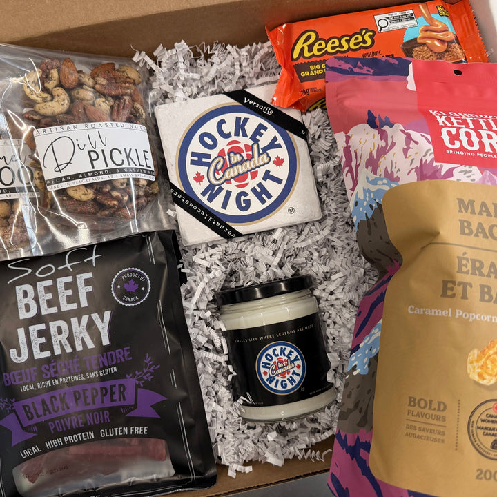 Assorted snack items including beef jerky, cookies, and popcorn in a box.
