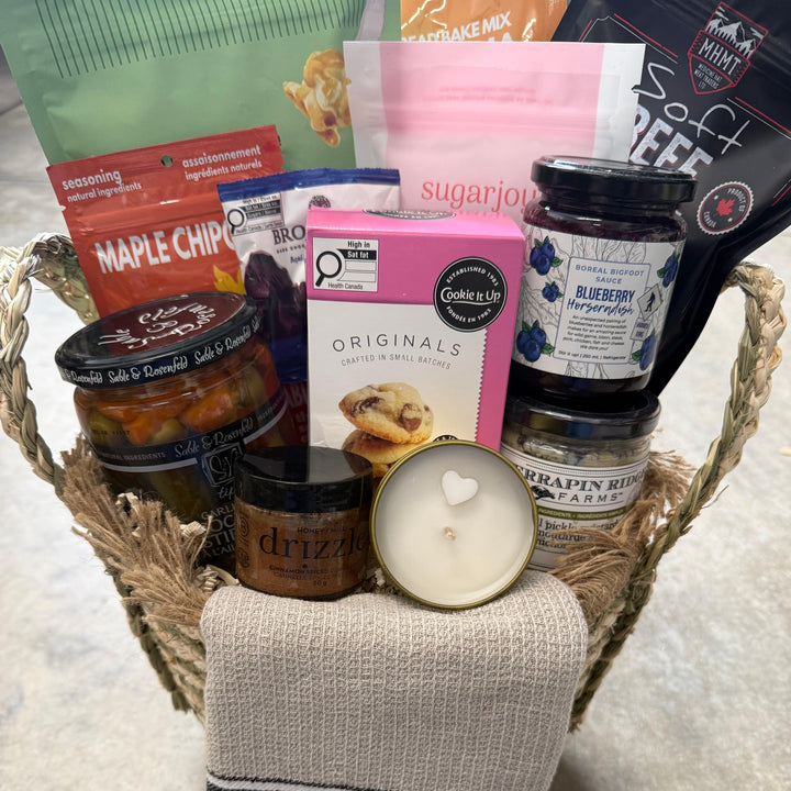 Basket with snacks, a candle, and a sock on a textured surface