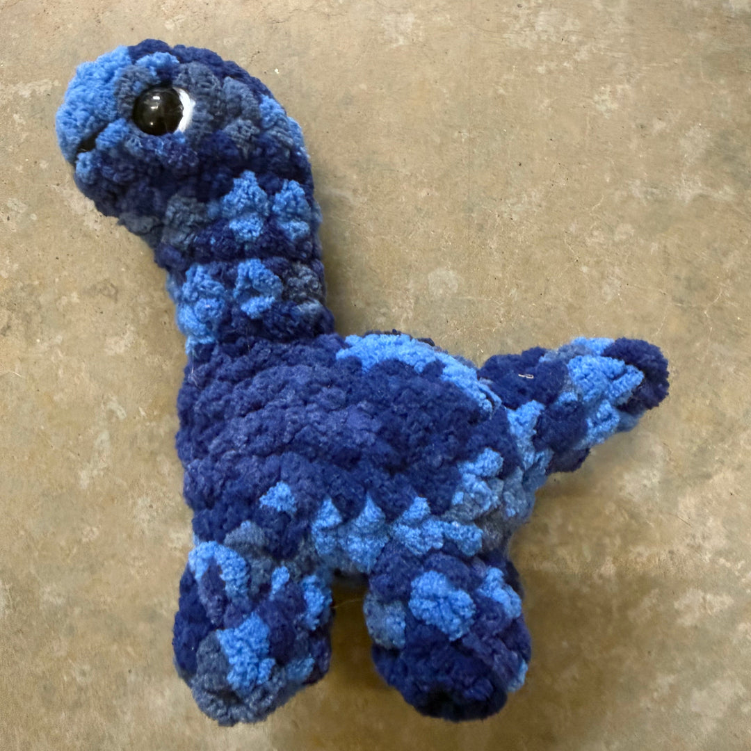 Blue knitted toy on a beige surface