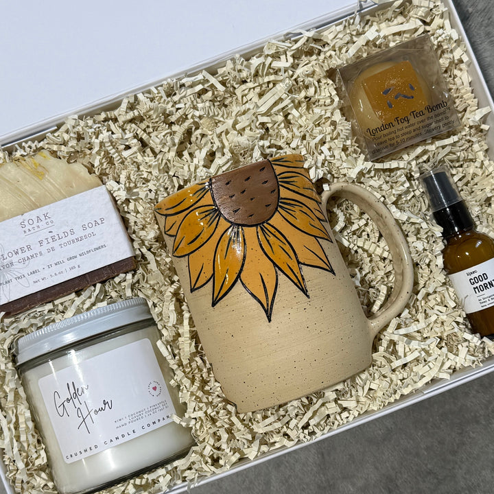 Gift set with mug, candle, soap, and bottle in a box