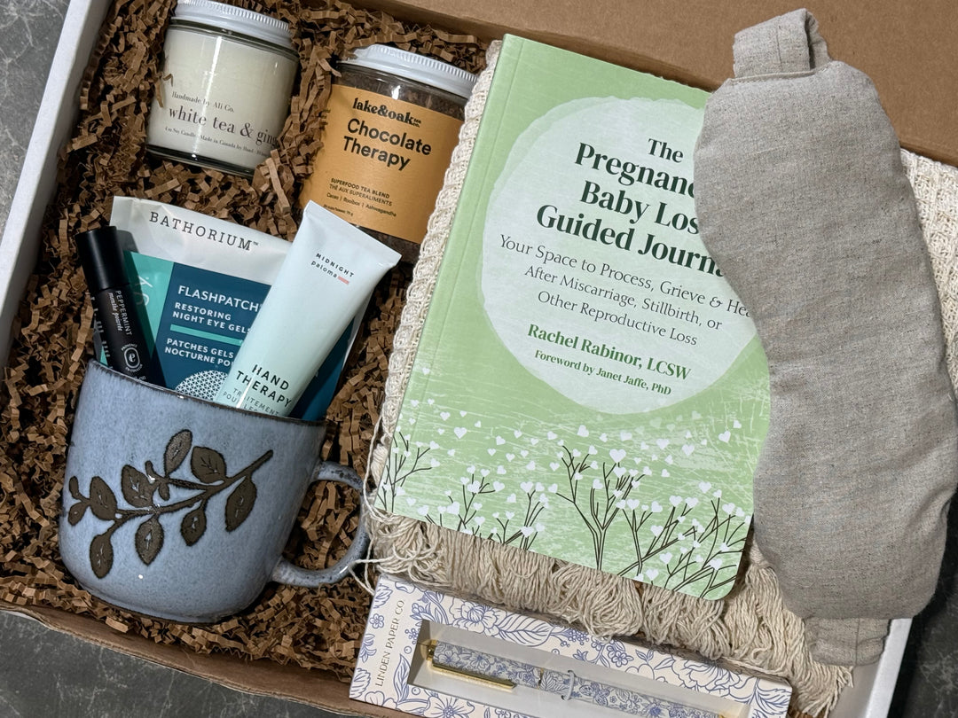 A curated gift box set containing a sage green &