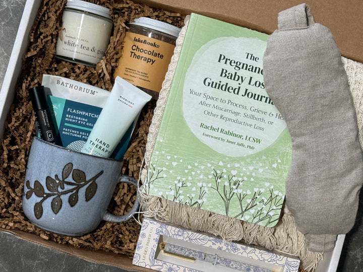 A curated gift box set containing a sage green &