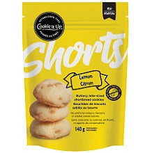 Packaging of Lemon Shorts shortbread cookies with the brand Cookie it Up visible. The package is yellow with images of the cookies on the front.