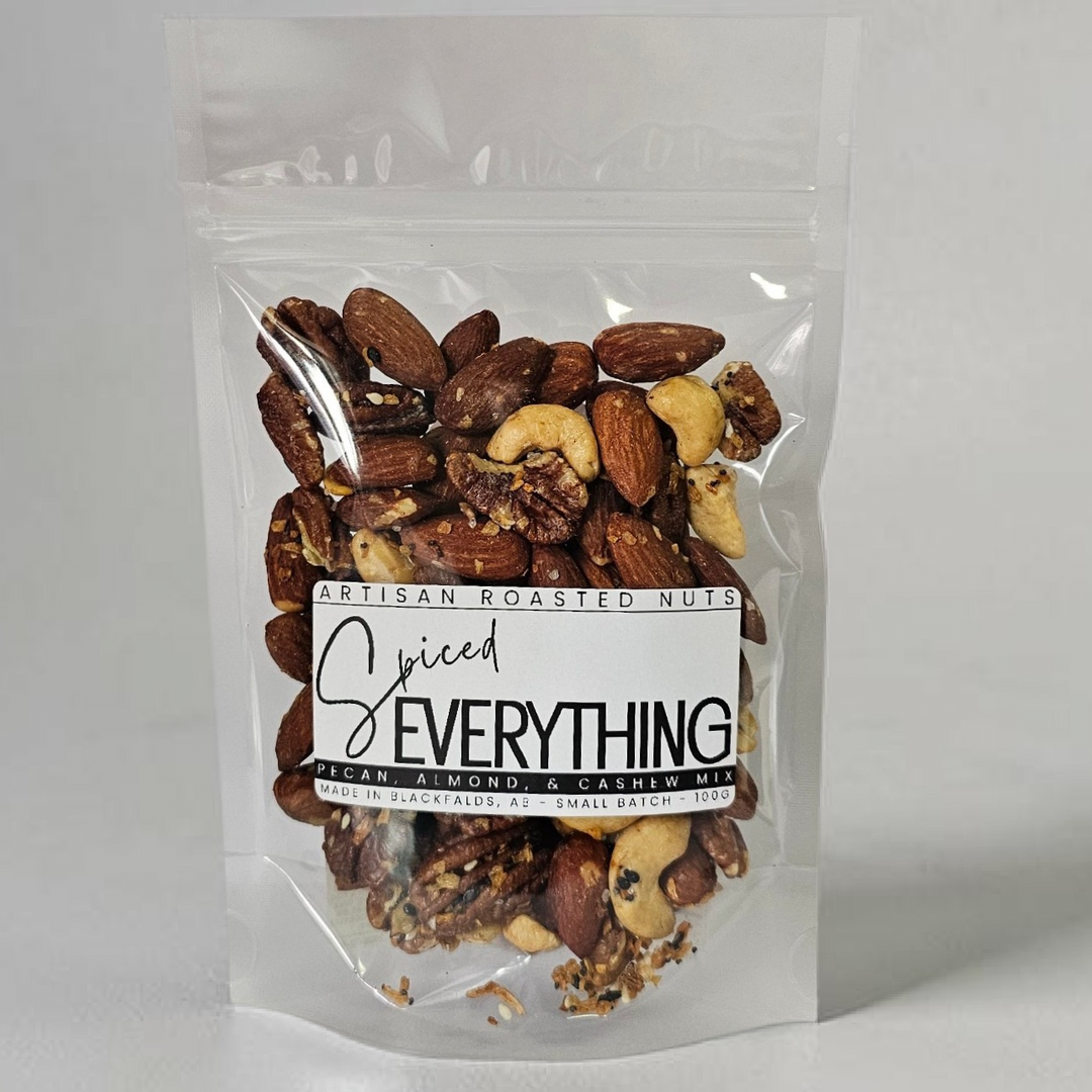 Packaged spiced nuts with a label on a gray background