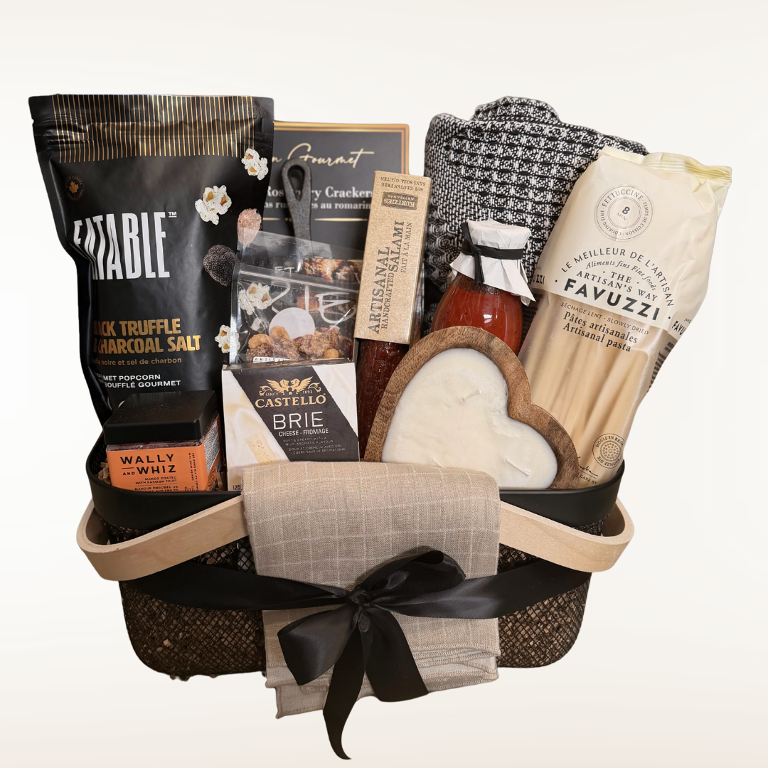 Gift basket with assorted items including a bottle of wine, cheese, and crackers on a white background.