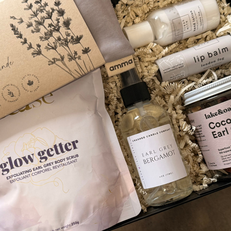Assorted beauty products including a bottle, tube, and pouches in a box with visible branding.