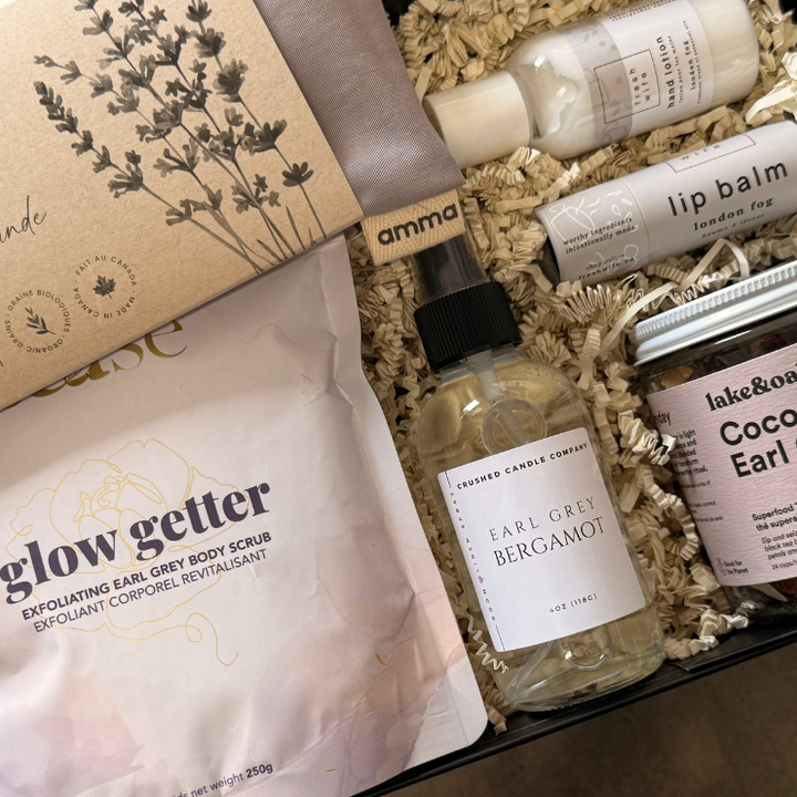 Assorted beauty products including a bottle, tube, and pouches in a box with visible branding.