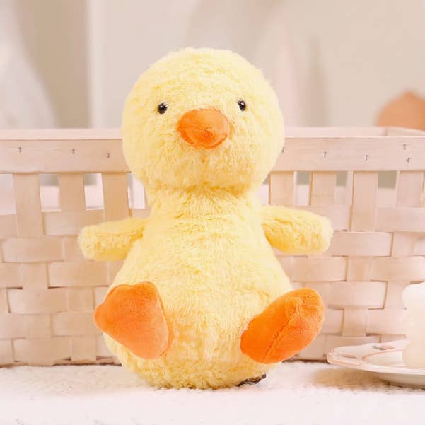 Yellow plush duck toy with orange feet and beak on a light background