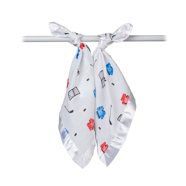 Two Lulujo Baby cotton security blankets featuring hockey-themed designs for babies, soft and cozy for comfort.