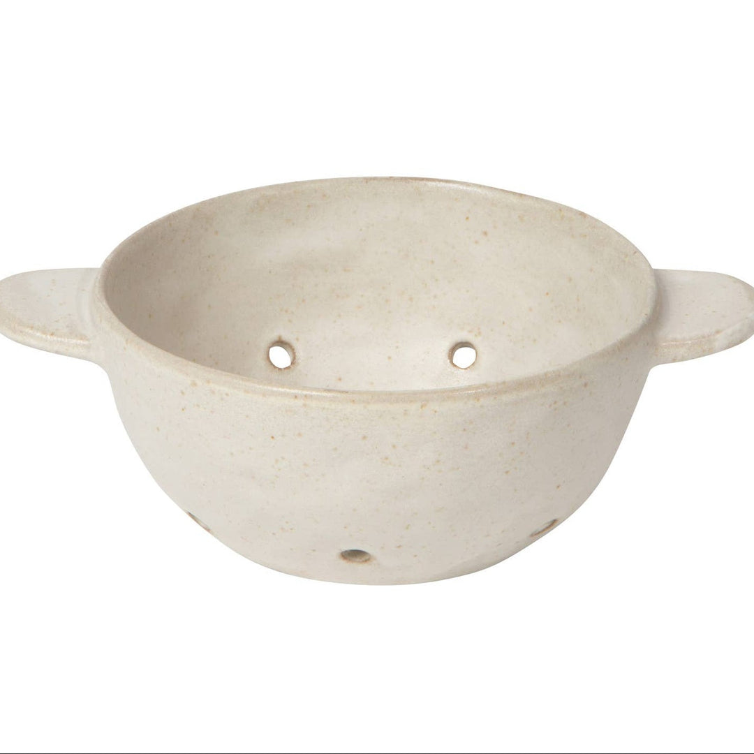 Beige ceramic colander with handles on a white background