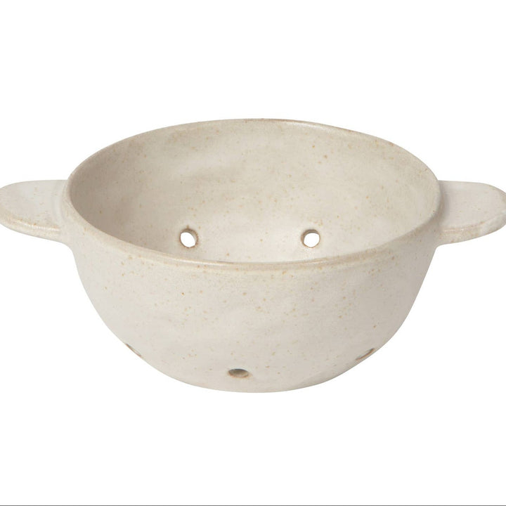 Beige ceramic colander with handles on a white background