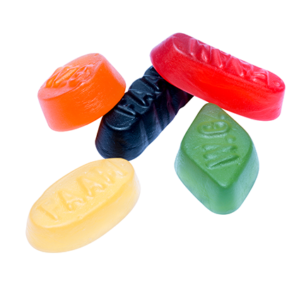 Colorful candy tablets with visible branding on a white background