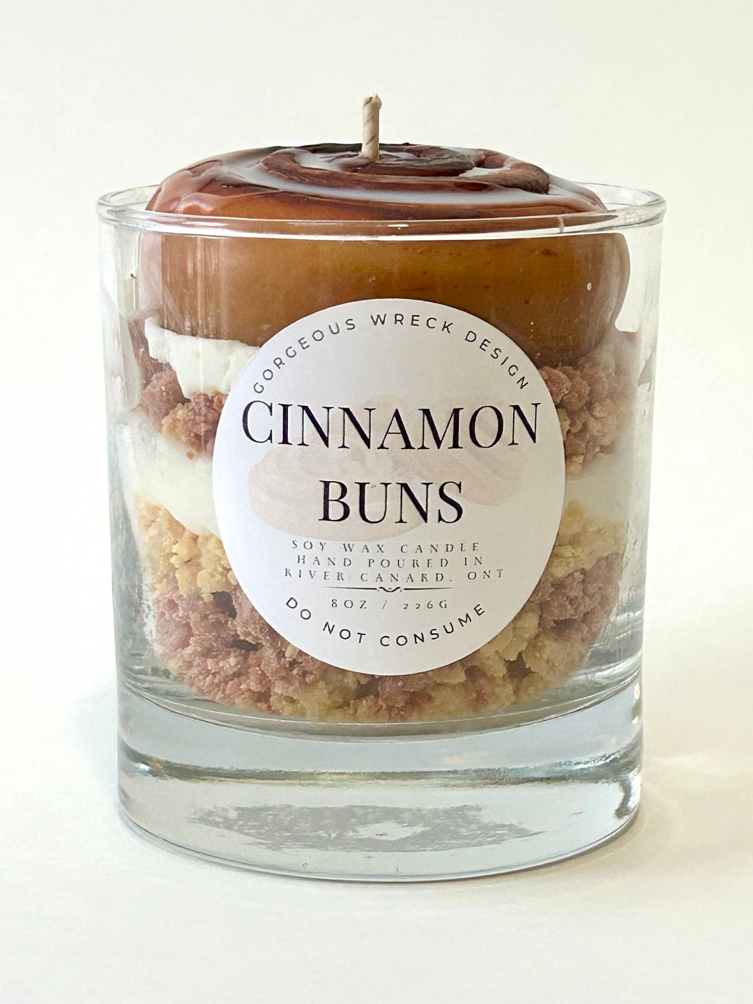 Candle in a glass jar labeled &