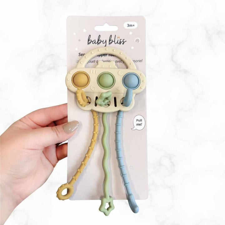 Baby teething toy with pastel colors on a white background