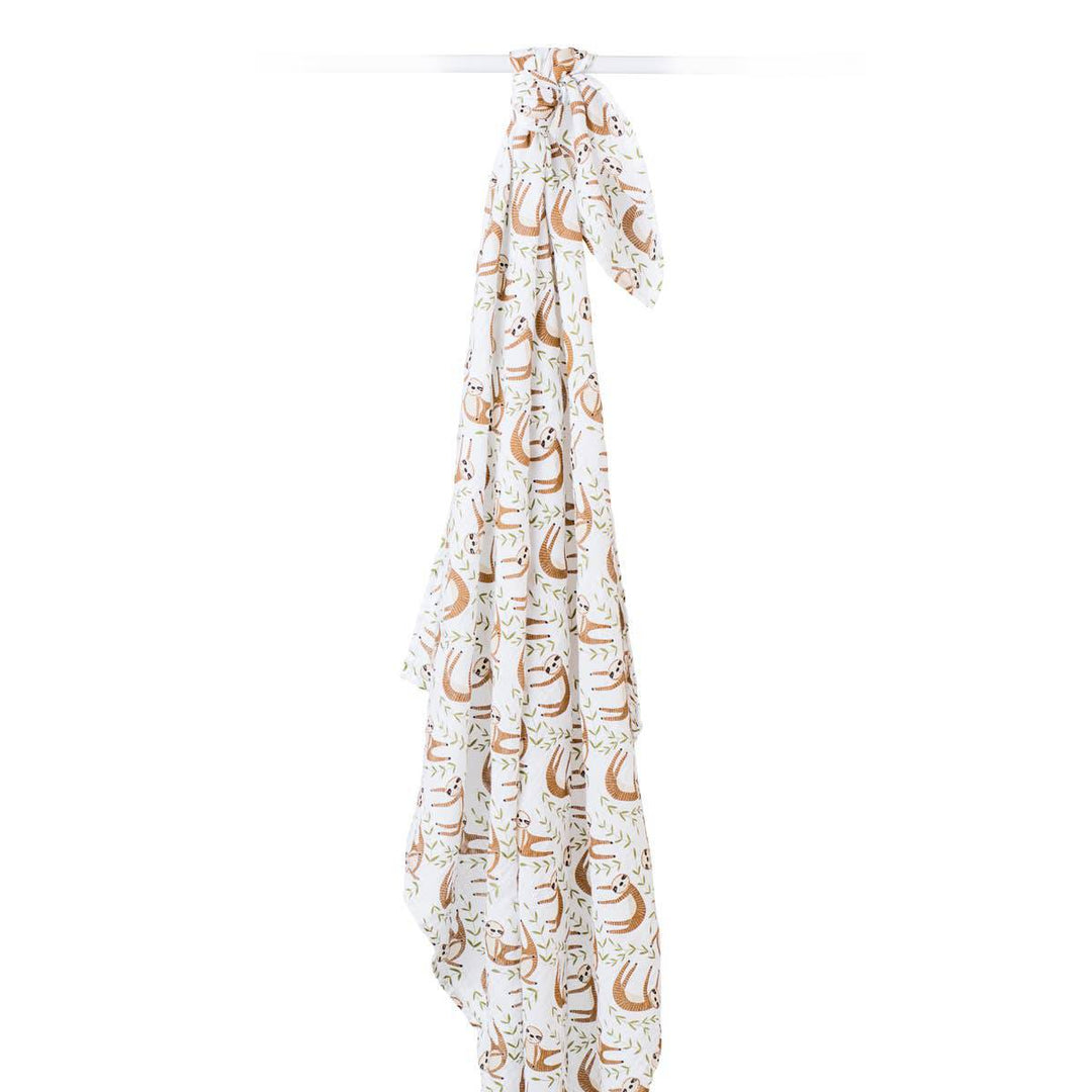 Soft muslin cotton swaddle blanket featuring a cute sloth design by Lulujo Baby, perfect for wrapping a newborn baby.