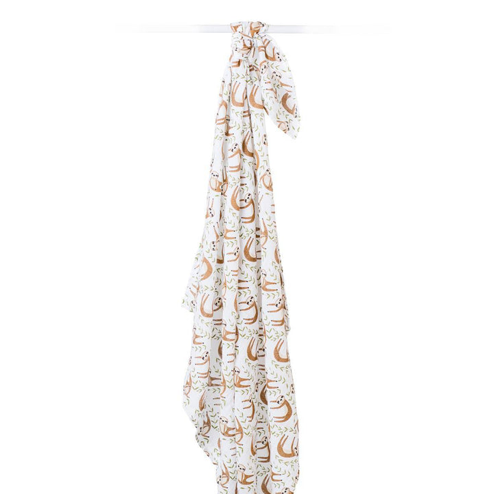 Soft muslin cotton swaddle blanket featuring a cute sloth design by Lulujo Baby, perfect for wrapping a newborn baby.