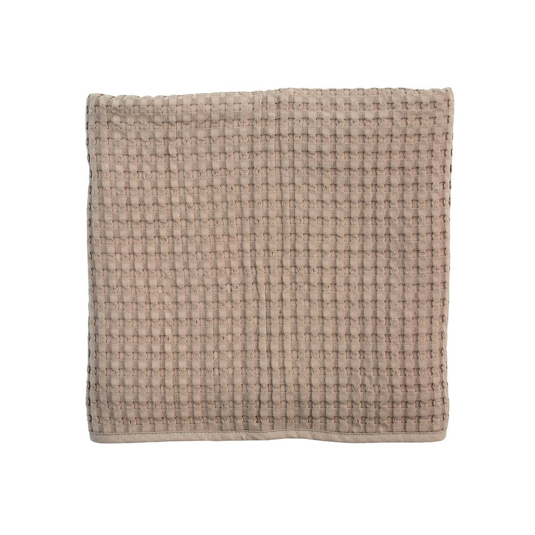 Textured beige square towel on a white background