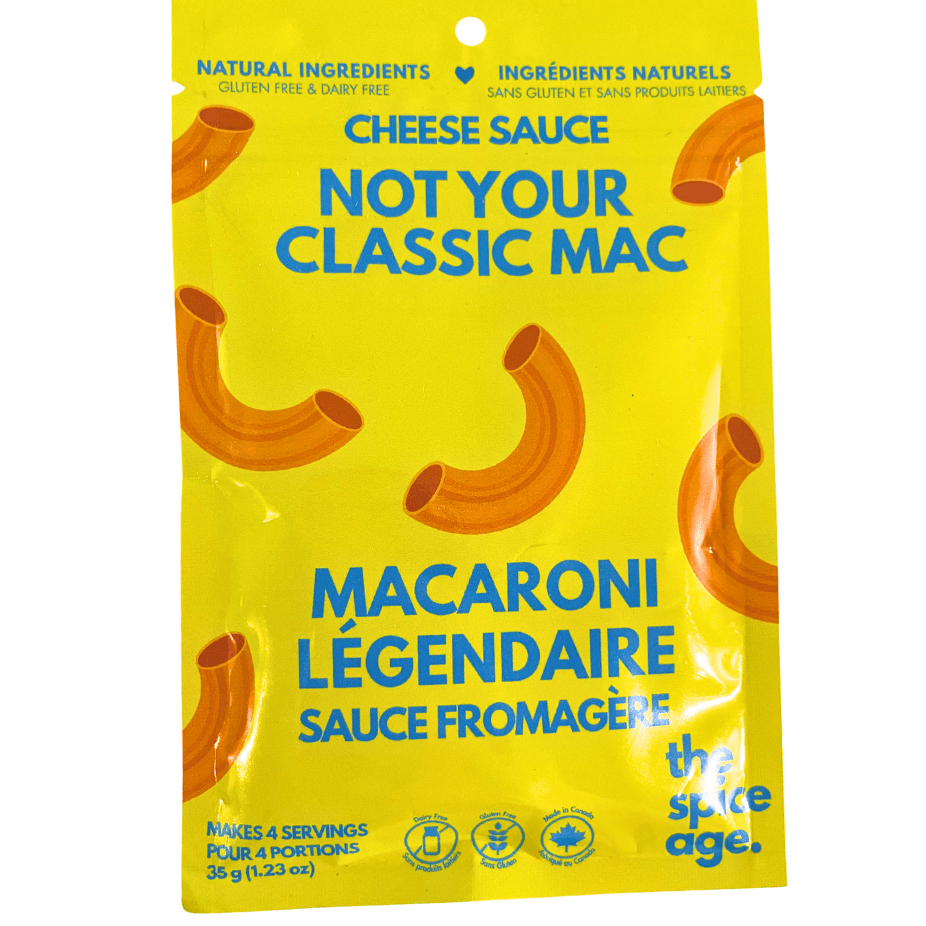 A jar of The Spice Age Mac &amp; Cheese Sauce in pantry, creamy cheese sauce for pasta, with label showing product details.