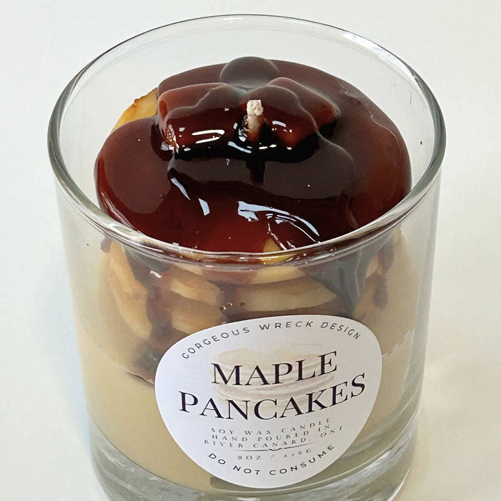 Candle in a glass jar labeled &