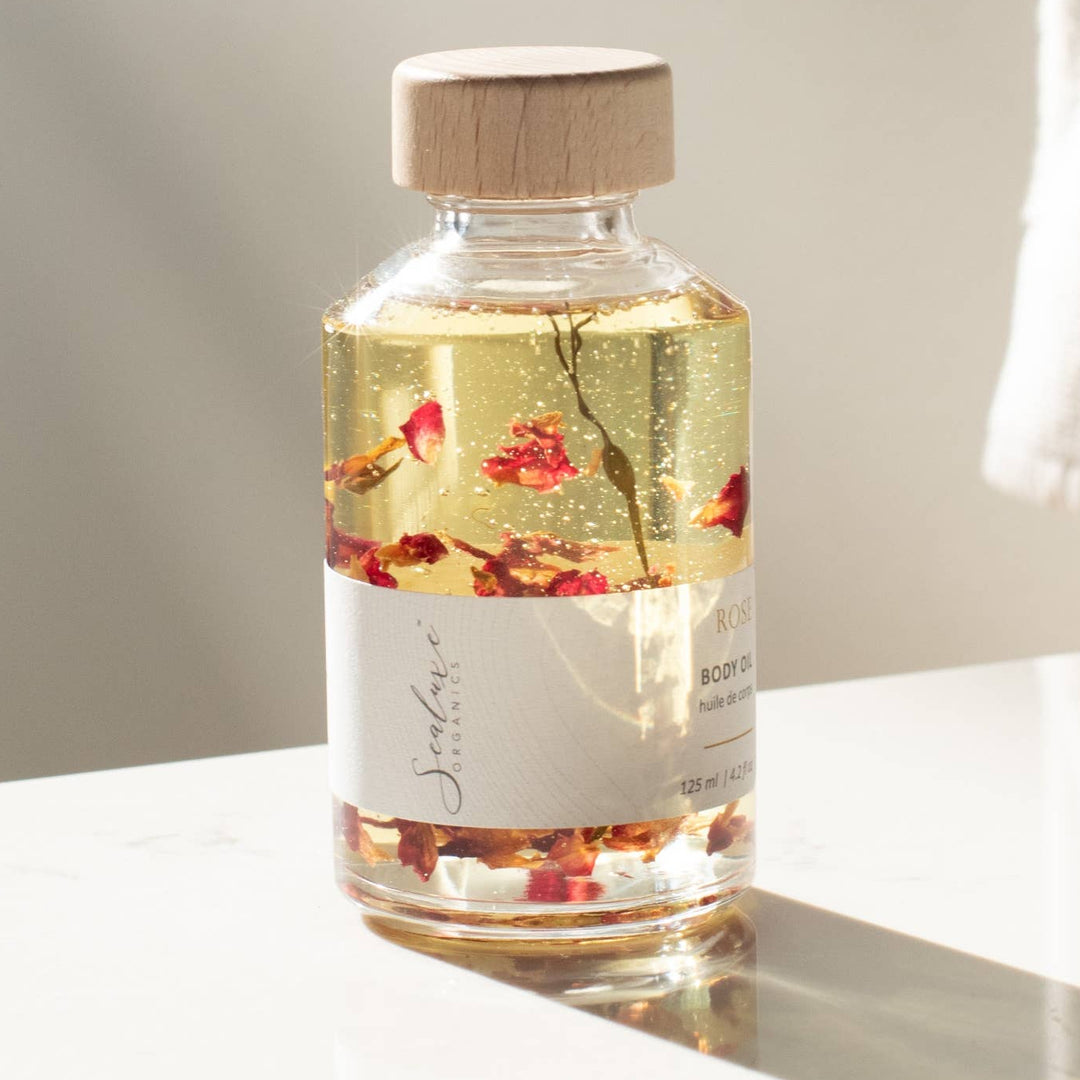 Glass bottle with wooden cap on a white surface with a blurred background