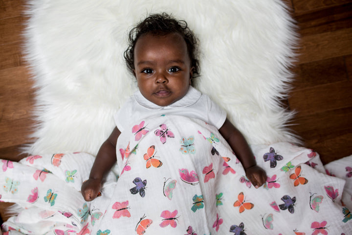 Soft Lulujo Baby muslin swaddle blanket with butterfly print, lightweight and breathable for comfortable swaddling.