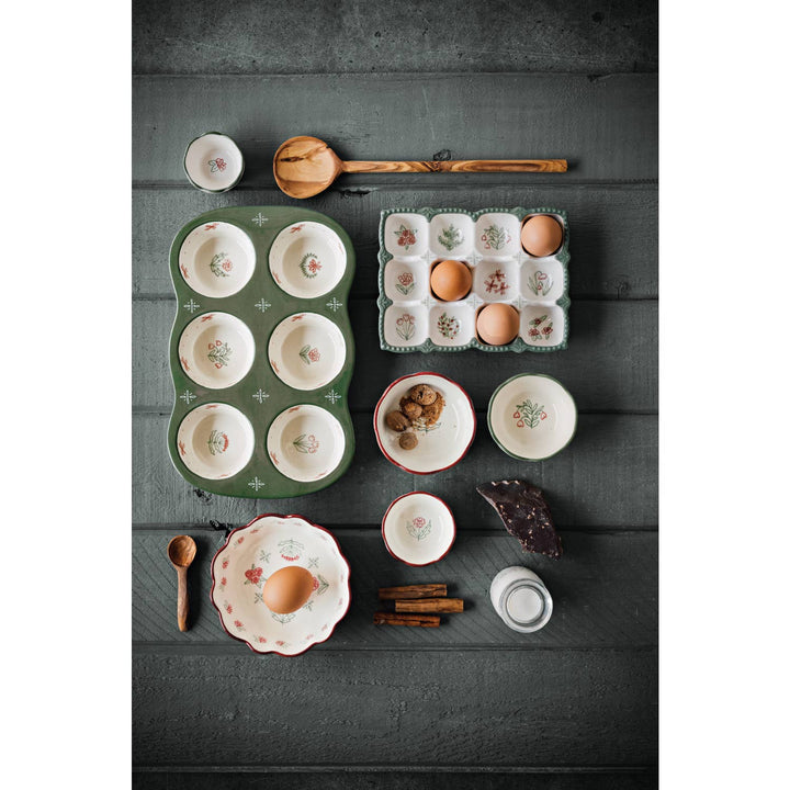 Collection of ceramic dishes and kitchen items on a dark wooden surface