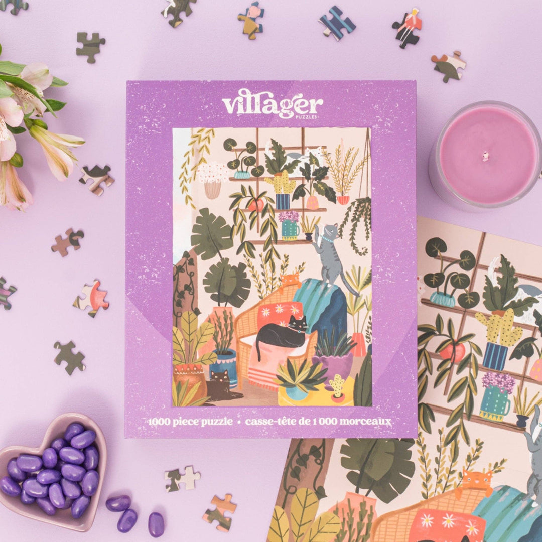 Villager puzzle box with a colorful illustration of a room with plants and cats on a purple background.