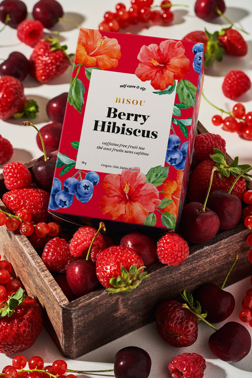 Organic Berry Hibiscus fruit tea blend sachets from Bisou Tea, featuring vibrant berry and hibiscus tea bags with colorful packaging.