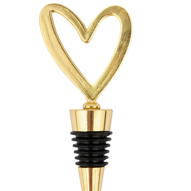 Gold heart-shaped bottle stopper on a white background
