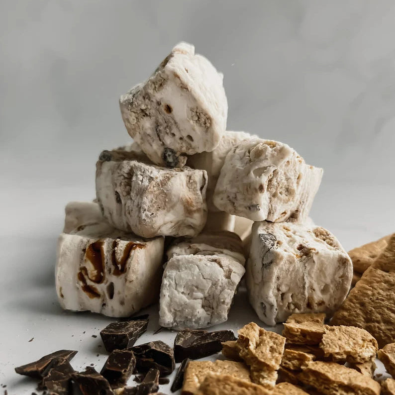 Stack of marshmallows with chocolate pieces on a light gray background