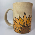 Ceramic mug with a sunflower design on a white background