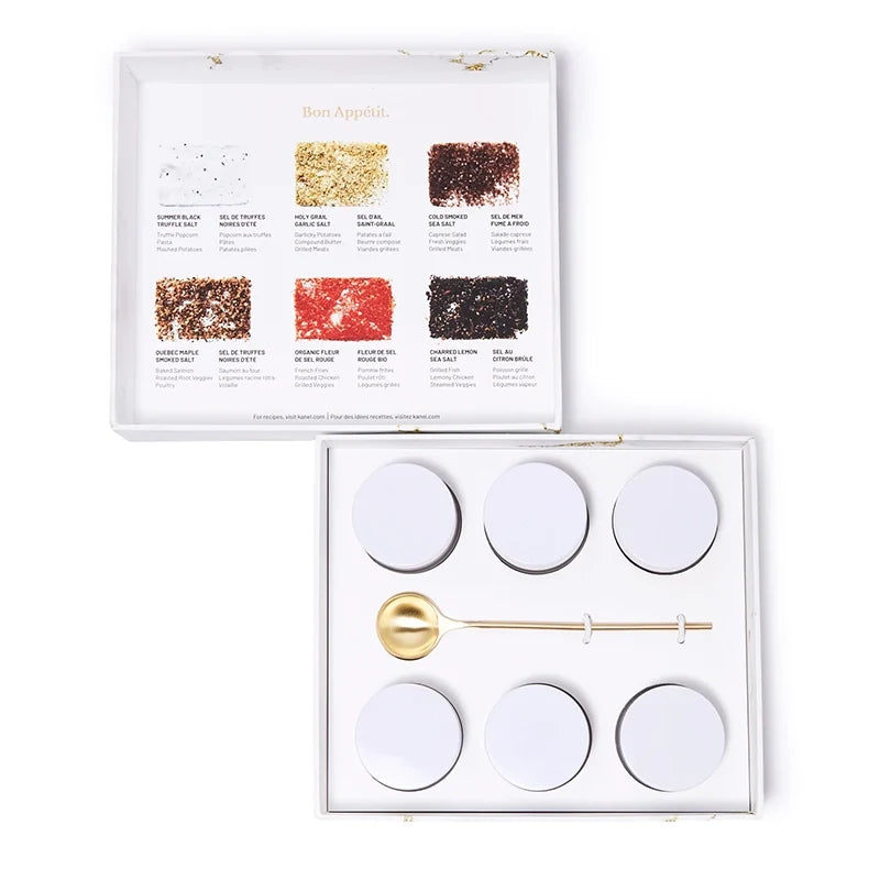 Set of white round containers with a gold spoon in an open box, featuring a branded lid.