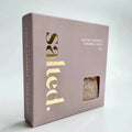 Box of salted caramels with 'salted.' branding on a light gray background