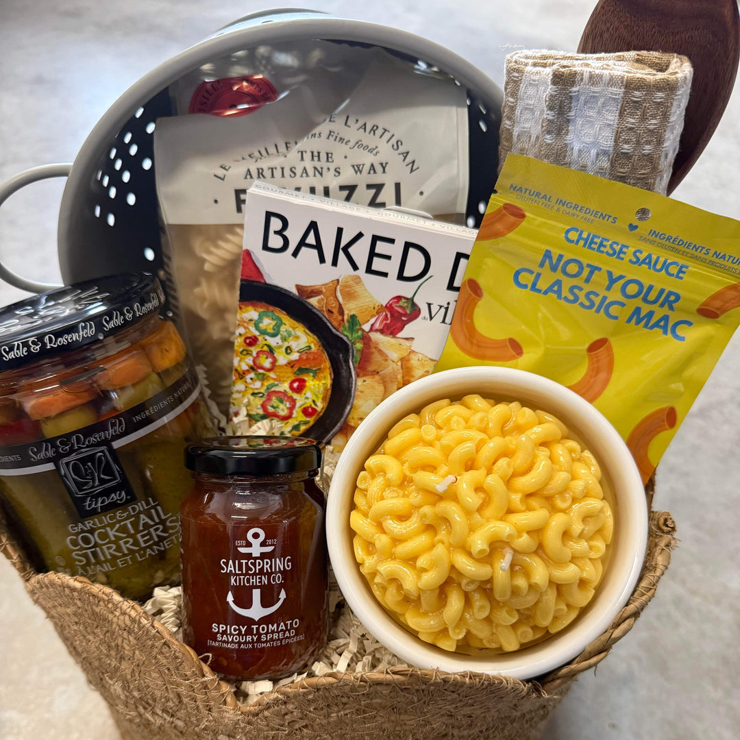 Gourmet gift basket with macaroni and cheese, hot sauce, and other snacks.