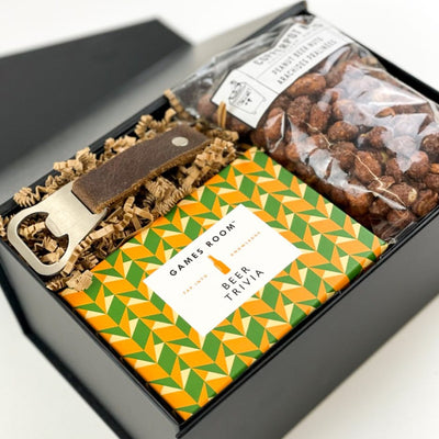 Happy Hour essentials they'll love! This beer-themed gift box is always a hit! GIFT CONTENTS:  Games Room Beer Trivia Leather Key Ring Bottle Opener Coppernuts Peanut Beer Nuts