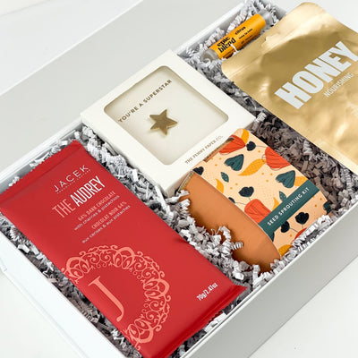Make them feel valued and appreciated with our Superstar Gift Box! This luxury gift box is filled with self-care treats they'll love.  GIFT CONTENTS:  JACEK The Audrey Chocolate Bar  Seed Sprouting Kit Superstar Gold Pin Epic Blend Citrus Lip Balm Honey Sheet Face Mask