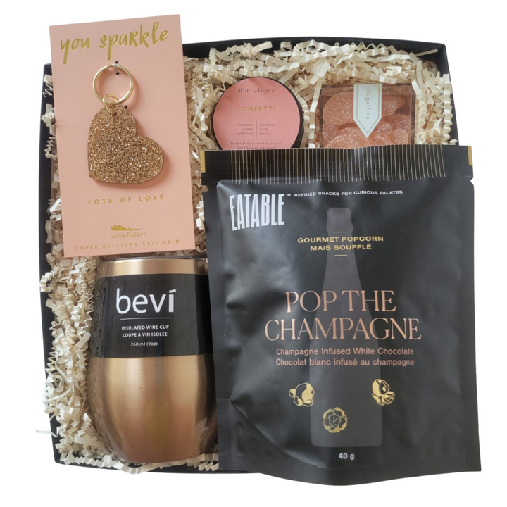 It's time to pop the champagne! This celebratory gift box includes five gifts they'll love: Lot's of Love Sparkly Keychain, Mimi & August Confetti Candle, Sugarfina Tequila Grapefruit Candies, Eatable Champagne Infused White Chocolate Popcorn, and Champagne Bevi Insulated Wine Cup.