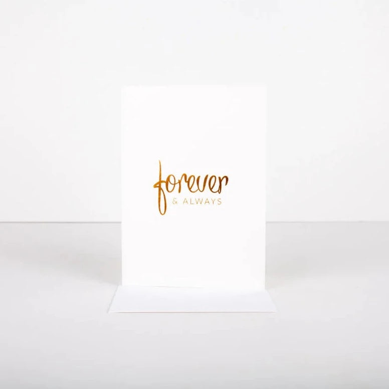 A simple, classic foil embossed card for a wedding, engagement or anniversary. Blank inside to add your own personal message. 3.75" W x 4.25" L 110lb Tree Free Cotton Paper Foil Embossed Gold Foil White Euro Flap Envelope Blank Interior