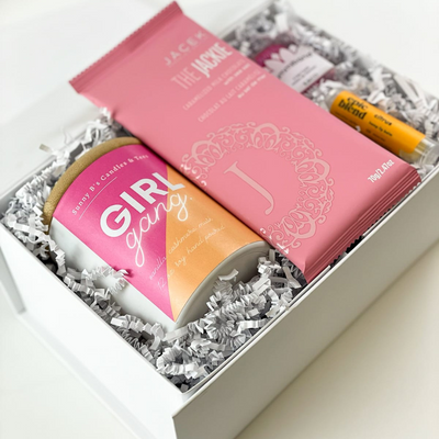 The perfect gift for Galentines! This luxury gift box is filled with fun feminine items that will give them the ultimate happiness boost!  GIFT CONTENTS:  Girl Gang Candle - Vanilla Cashmere Musk The Jackie JACEK Chocolate Bar - Caramelized Milk Chocolate Epic Blend Citrus Lip Balm Pink Gummi Band Hair Cords
