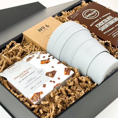 Time for a break! This luxury gift box is a coffee lover's dream! Whether it's for a friend's birthday or an employee's promotion, it will bring a smile to their face and some pep to their step.   GIFT CONTENTS:  Stojo Travel Cup No 6 Coffee Instant Coffee Packs Cookie It Up Chocolate Shortbread