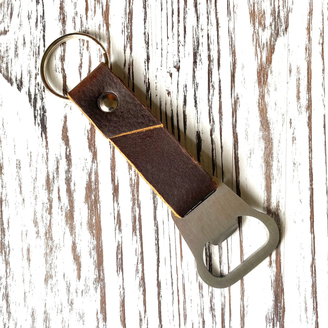 The original bottle opener keychain is a must have for any special dude in your life. This minimalist leather bottle opener is the perfect addition to your keys. All keychains are made from genuine leather cow hide. Expect the leather on your keychain to soften and age beautifully with use. Every part of this keychain is handmade.