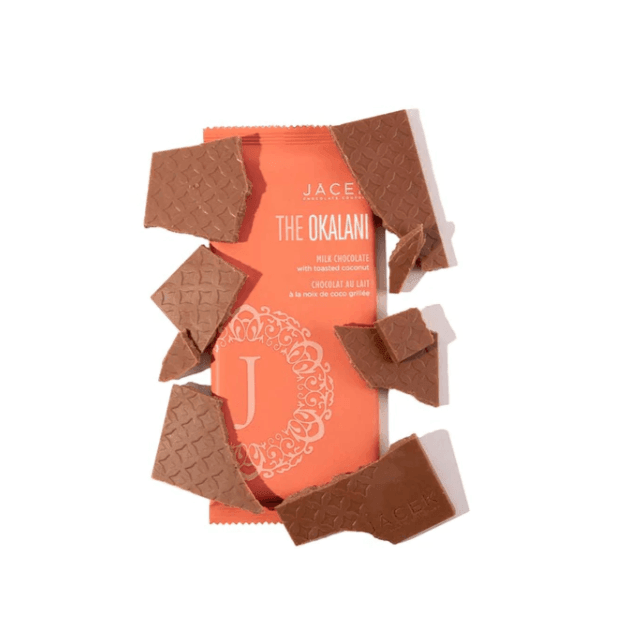 Meet Okalani, the bar that whisks you away to the tropics.  The Okalani pays homage to the effortless beauty of a beachy floral dress. Like the ease of donning an airy gown, this milk chocolate bar invites you to enjoy the mellow & easy-going flavours of toasted coconut.  The Base: Milk chocolate The Embellishments: Toasted coconut flakes  Weight: 70g
